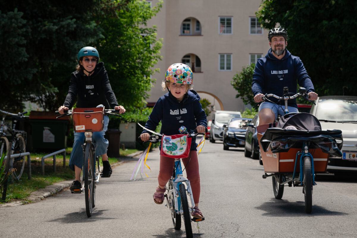 Eine Familie in OstSeele-Shirts fährt Rad